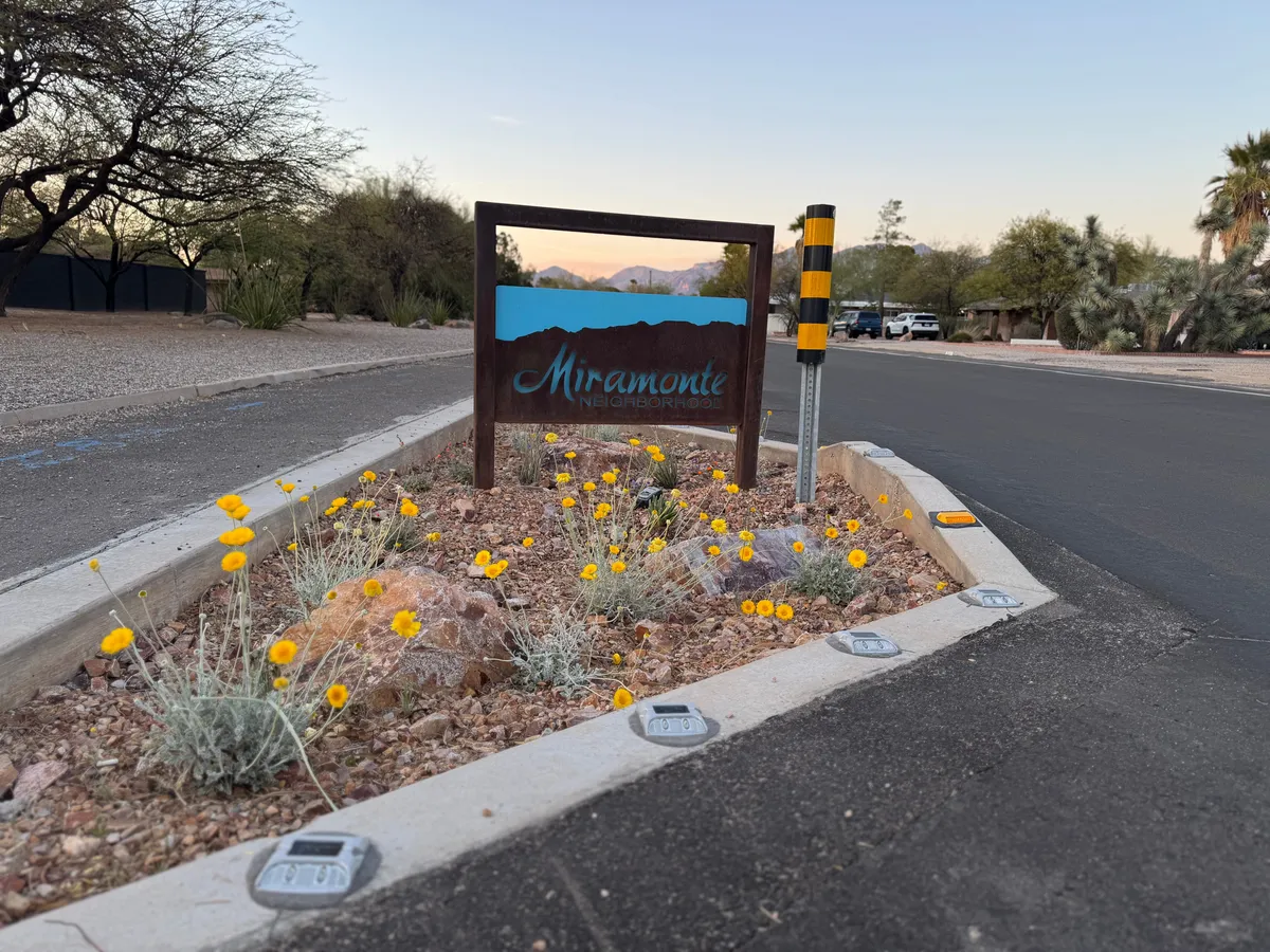 The Miramonte neighborhood entrance sign in a planted median at dusk